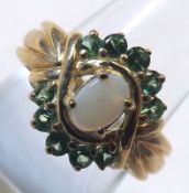 A 9ct Gold hallmarked Ring set with a White Opal and ten Tsavorites