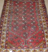 A 20th Century Caucasian Rug, multi-gull border, central panel of geometric designs mainly red