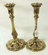 A pair of Victorian previously Electroplated Candlesticks with multi-lobed and loaded circular