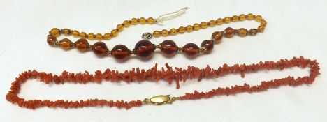 A Coral or Composition Necklace and a further Amber type Necklace
