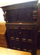 A large 19th Century Oak Court Cupboard, the top with two heavy doors with arched detail, the base