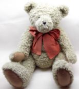 A Boyd Teddy Bear, grey fur covering with large bow, height 27”