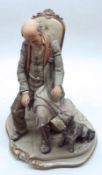 A 20th Century Capodimonte Model of a seated figure with attendant dog, 10” high