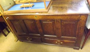 An 18th Century Oak Mule Chest of typical form, hinged lid, void interior, four panelled front to