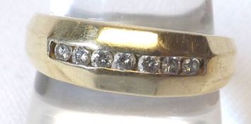 A yellow metal Ring marked 10K set with seven small Diamonds