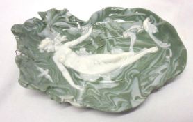 A Novelty Wall Plaque decorated with a raised design of a naked female figure on a marbled