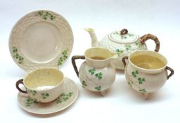 A Belleek part Tea Service typically decorated with shamrock detail, comprising Teapot, four Cups,