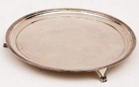 An Elizabeth II large Round Three-footed Tray, the ribbed border to a plain centre, raised on