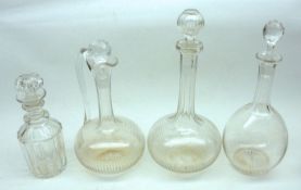 A group of four late 19th/early 20th Century Clear Glass Decanters, comprising three onion-shaped,