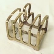 A Silver Plated Four Slice Toast Rack of plain form