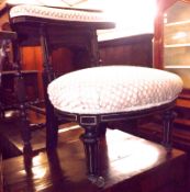 A late 19th Century Ebonised and Gilded Aesthetic Style Nursing Chair, upholstered in beige