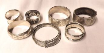 A Mixed Lot: various Silver and white metal Bangles, together with a Chester hallmarked Napkin Ring,