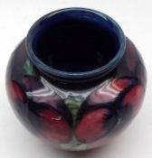 A small Squat Moorcroft Wide-Necked Vase, decorated with pansies on a blue background, the base