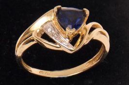 A yellow metal Ring marked 10K set with blue stone and Diamond chips