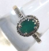 A yellow metal Emerald and Diamond chip set Ring