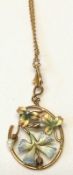 An early 20th Century yellow metal Pendant of oval form, inset with twining enamelled foliage and