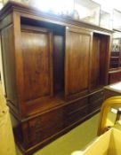 A large Eric Bates Bespoke Oak Wardrobe, fitted with three panelled doors above six drawers with