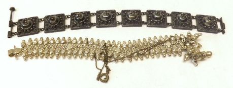 An Oriental white metal Fringe Bracelet; together with an Ethnic white metal Panelled Bracelet (2)