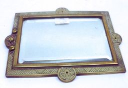 A Cast Brass framed Wall Mirror of rectangular form, the frame embossed with geometric designs, with