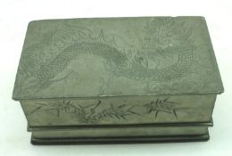 A Chinese Pewter Box of rectangular form, with pull-off lid, impressed with dragons and sprigs of