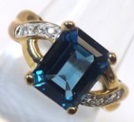 A hallmarked 9ct Gold Ring set with a London Blue Topaz and small White Topaz