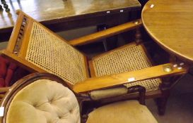 An early 20th Century Fruitwood Planters type Chair, with cane back and seat and swivelling