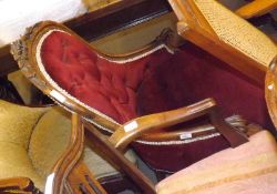 A Victorian Walnut Ladies Chair with spoon back, swept arms terminating in scrolls, joined by a