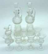 A pair of small Clear Cut Glass Whisky Decanters with handles, decorated with a thistle design;