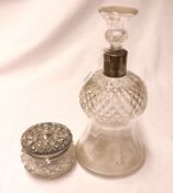 An early 20th Century Clear Cut Glass Decanter, with waisted body on a round foot and star cut base,