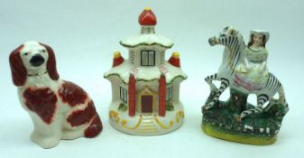 A Mixed Lot of three 19th Century Staffordshire Ornaments: a Figure astride a zebra, on plinth base;