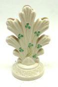 A 20th Century Belleek Three Branch Spill Vase, decorated with shamrock design on a cream