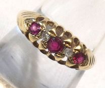 An 18ct Gold hallmarked Ring set with three Rubies and two small Diamonds