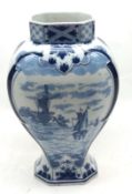 A 20th Century Delft Vase, typically decorated with blue panels of canal scene and floral sprays, on