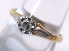 An 18ct Gold hallmarked Ring set with solitaire Diamond in a floral setting