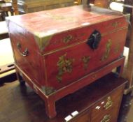 An Oriental Panted and Lacquered Small Trunk on Stand, with brass bound corners and the lid, sides