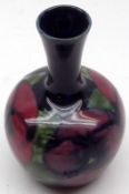 A small Moorcroft Narrow Necked Vase, decorated with a pansy pattern on a blue background, the