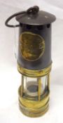 A Hailwoods Improved Miners Lamp, lacks burner and appears to have solder repair to base, 10” high