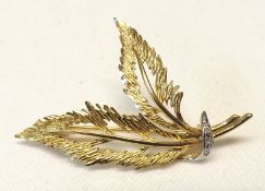 A hallmarked 9ct Gold Twin Pierced Leaf Design Brooch with small Diamonds mount and weighing