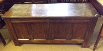 An 18th Century Oak Coffer of typical form, plain board hinged top to an interior fitted with candle