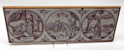A Framed Group of three 18th Century Delft Religious Tiles (two cracked), decorated in puce on a