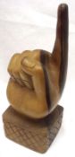 A 20th Century Carved Hardwood Hand with one finger raised, 13” high