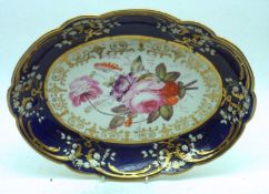 A 19th Century Shaped Oval Side Dish, decorated with a central spray of flowers to a blue and gilt