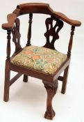 A Georgian style Child’s Corner Chair, with bowed back, pierced splats, turned supports, raised on a