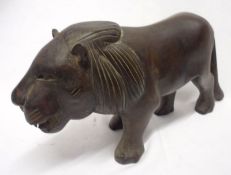 A 20th Century Carved Hardwood Model of a lion, 10” long