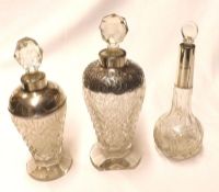 A Mixed Lot: three Cut Clear Glass Dressing Table Bottles with stoppers, all fitted with silver