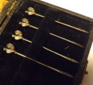 A Case containing four (of six) Cocktail Sticks with cockerel finials, 3” long, Birmingham 1923