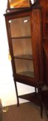 An Edwardian Mahogany Corner Cabinet with inlaid banding, fitted with single glazed door, raised