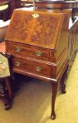 A 20th Century Walnut Small Queen Anne Style Bureau, the crossbanded fall front enclosing an