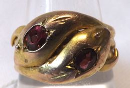 A hallmarked 9ct Gold Gents Ring, modelled as coiled snakes and inset with Ruby or Garnet stones