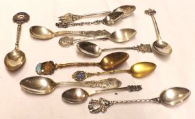 A collection of eleven hallmarked Silver/white metal Souvenir Spoons, some with enamelled finials